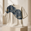 Night Current oversized cream T-shirt carrying a midnight-blue art fragment across the shoulder and chest